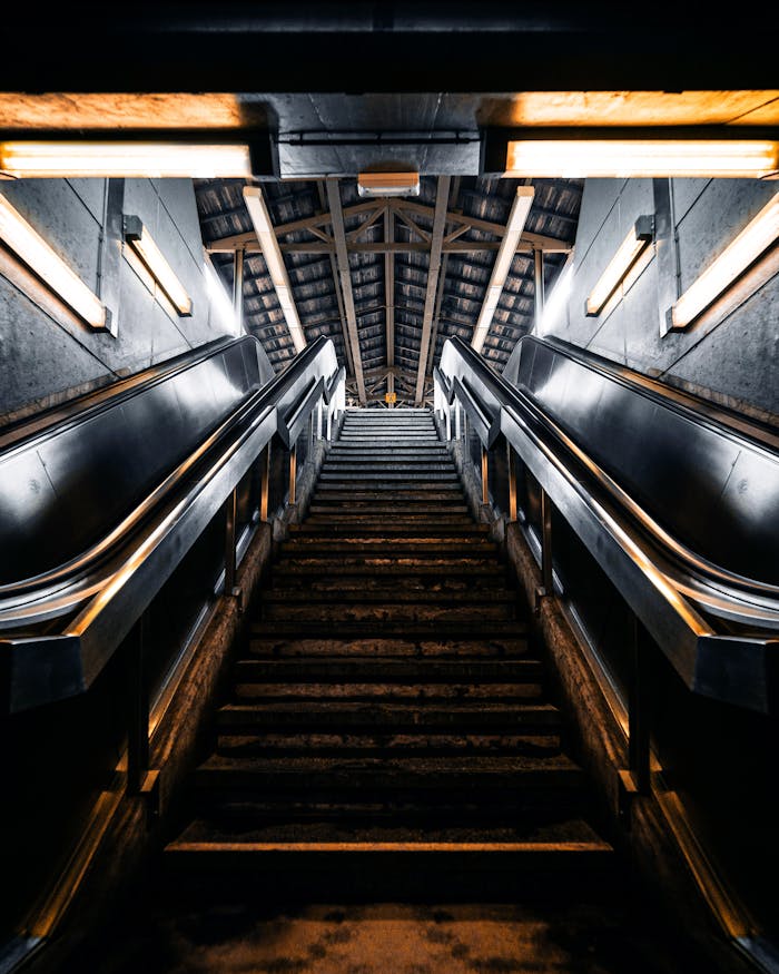 Accueil A dark and atmospheric view of an escalator in an underground subway station in Charleroi, Belgium.